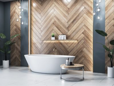 A modern bathroom with a freestanding bathtub, herringbone wood accent wall, and contemporary decor.